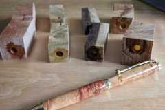 Pen blanks prepared for turning and a finished Box Elder burl pen.